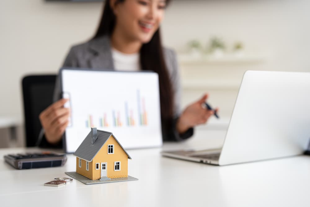 an image of a female banker giving a presentation to help describe the best mortgage rates lincoln ne from Liberty First Credit Union